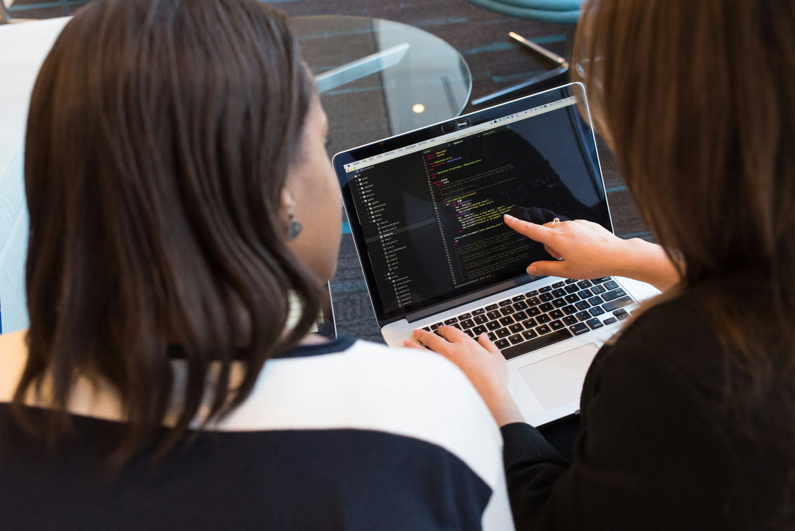 two women in tech reviewing code
