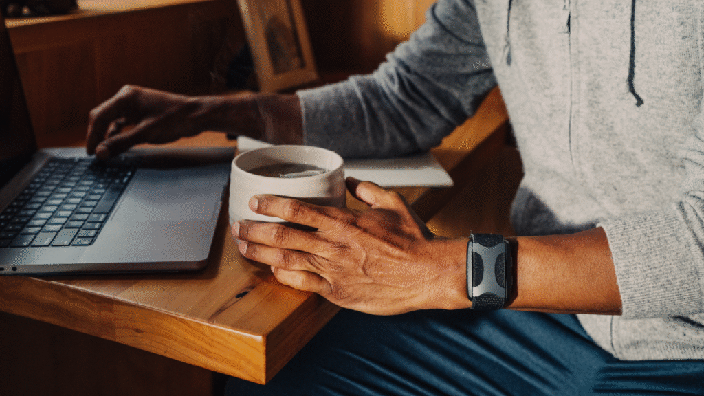 Apollo Wearable on Wrist Man Working at Desk