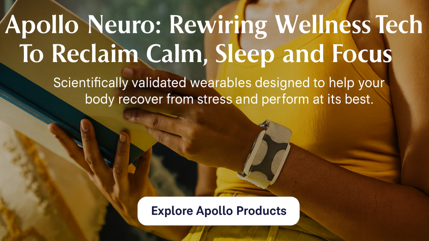 Woman wearing Apollo Neuro wearable wristband while reading a book in a relaxed indoor setting.