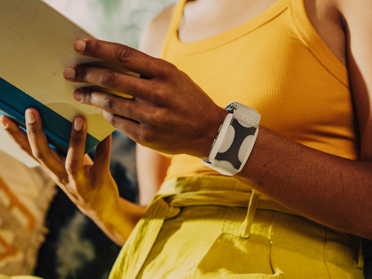 Woman wearing Apollo Neuro wearable wristband during meditation for stress relief and nervous system regulation